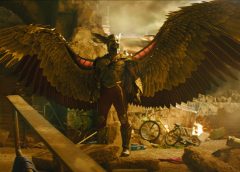 Hawkman posing with destruction around him.